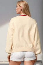 Nutcracker-themed cream bomber jacket with red trim and white shorts