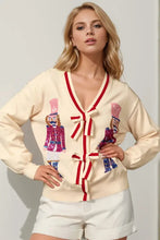 Cream cardigan with nutcracker appliques, red trim in turquoise jacket set