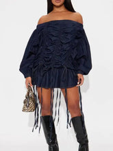 Navy blue off-shoulder ruched denim dress with long sleeves and fringe detailing in a ruched denim mini dress style