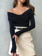 Black off shoulder ruched long sleeve bodysuit with fitted silhouette and soft stretch fabric for stylish wear