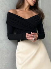 Black off-shoulder long sleeve bodysuit features ruched fabric with v-neckline for stylish and fitted wear