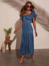 A flowing blue denim dress with shoulder ruffle tiered details and a midi length perfect for casual wear
