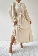 Cream-colored textured balloon sleeve dress with honey tied button waist
