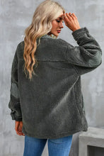 Charcoal gray oversized sherpa jacket with olive green accents, pockets, and sleeve length options