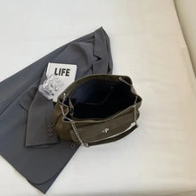 Olive green leather shoulder bag with chain strap and black interior