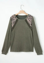 Olive green ribbed knit top with leopard shoulder accents and beaded patches