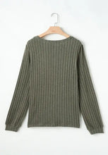 Olive green ribbed knit top with leopard shoulder accents and semi-sheer stretch