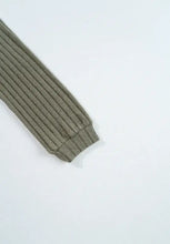 Olive green ribbed knit top with leopard shoulder accents and gray striped tie