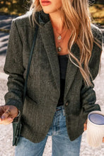 Olive green textured blazer with black zipper and pocket details