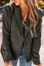 Olive green herringbone blazer with single button closure and pocket details