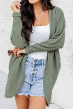 Olive green waffle knit cardigan with frayed hem shorts and white tank top