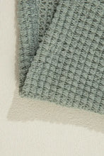 Mint green textured rug with woven pattern and soft pile