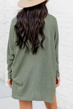 Olive green waffle-knit sweater dress with long sleeves and relaxed fit