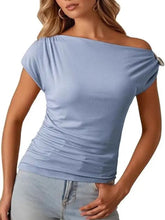 Light blue ribbed blouse with one-shoulder design short sleeves and decorative button detail on the shoulder