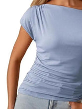 Light blue ribbed blouse with short sleeves and a ruched neckline in a one-shoulder design