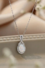 Elegant opal pendant necklace with sterling silver chain and blue oval gemstone