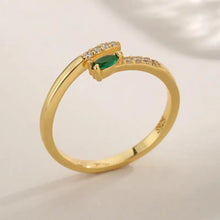 Sterling silver open ring with marquise green emerald and clear accents