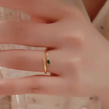 Sterling silver open ring with marquise green gemstone and diamond accents