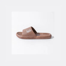Brown open toe flats slipper with textured footbed and bear strap emblem