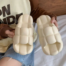 Pair of cream puffy open toe flats slippers sandals