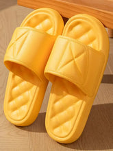 Pair of bright yellow quilted-strap open toe flats slippers