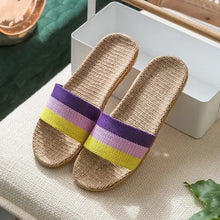 Pair of tan woven open toe flats slippers with colorful striped straps