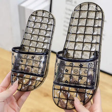 Pair of translucent dark gray open toe flats slippers with star motifs