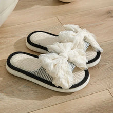 Open toe flats slippers with black trim and ruffled white bows