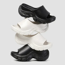 Stack of black and white open toe platform slippers