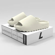 Pair of light-colored open toe platform slippers with thick textured sole