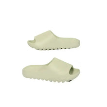 Pair of light green open toe platform slippers with ridged soles