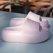 Pair of light pink open toe platform slippers with thick soles