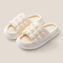 Pair of white textured open toe platform slippers with thick soles