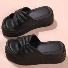Two black open toe platform slippers with ruched straps