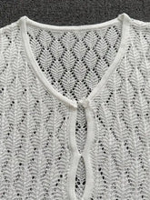 White openwork knit dress with lace pattern and floral button back