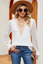 White long sleeve V-neck blouse with lace sleeves and tan trim