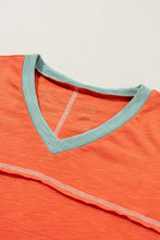 Orange and teal V-neck short sleeve t-shirt with contrast stitching