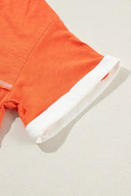 Orange and white drawstring shorts with teal v-neck short sleeve t-shirt