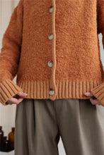 Orange fuzzy long sleeve cardigan with collared neck button front