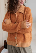 Orange fuzzy long sleeve cardigan with collared neck button front