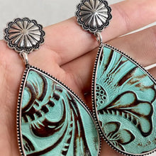 Ornate alloy teardrop earrings with turquoise embossed faux leather and silver conchos