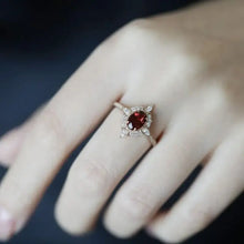 Oval cut ruby and diamond halo ring in sterling silver with matching box