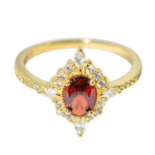 Oval cut ruby and diamond halo ring in sterling silver with matching box