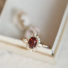 18k gold garnet engagement ring with diamond accents.