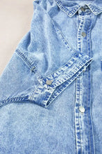 Light-wash oversized denim shirt dress with short sleeves silver-toned buttons and reinforced stitching details