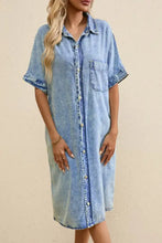 Oversized light-wash denim shirt dress with short sleeves and button-front design perfect as a casual denim shirt dress