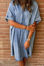 Oversized button down denim shirt dress in light-wash denim with short sleeves and a loose-fitting button-front design