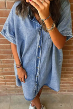 Oversized button down denim shirt dress in medium wash with short sleeves and loose fit button front design