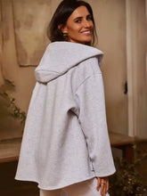 Light gray oversized dropped shoulder hoodie with soft textured fabric and relaxed silhouette machine wash cold
