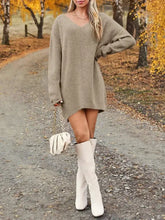 Woman in oversized knit sweater dress and knee-high boots